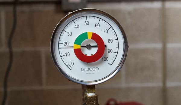 Close-up of a pressure gauge with a 0-100 scale currently reading 17.