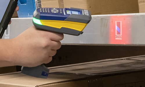 An associate using an RFID scanner to check inventory.