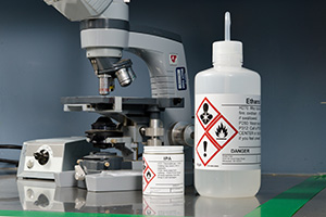 An image showing various lab equipment with GHS labels affixed to them.