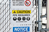 A fence with a danger, caution and notice sign to highlight potential cautions.