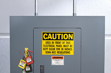 An electrical panel with a caution and warning label along with four lockout devices to provide proper safety.