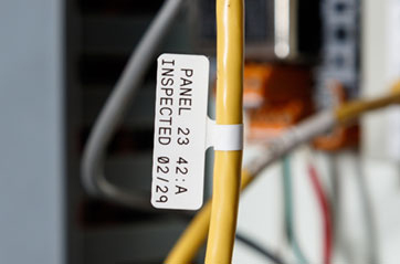 Wire with a securely attached cable label featuring clearly marked inspection dates.