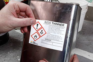 A HCS compliant label located on a chemical container.