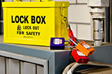 A box locked with a device that has several padlocks attached to it.