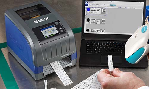 A scientist using a barcode scanner to scan a barcode on a laboratory label.