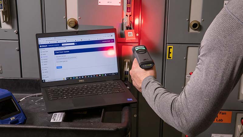 A worker scans a QR code on a lockout padlock that is digitally tracked using software.