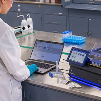 A technician connecting a laptop easily to the J7300 printer.