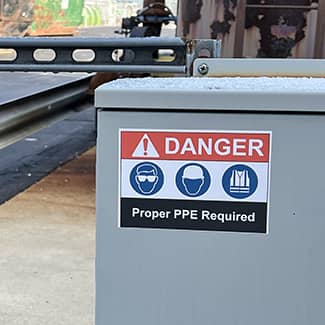 A clear, crips danger label printed with a J7300 printer shown on a piece of industrial equipment.