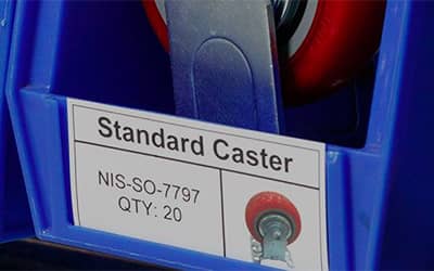 A caster wheel stored in a bin using a visual label including a photo of the caster.