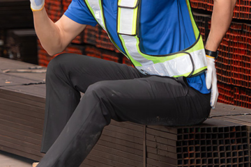 A man holding his back in pain.