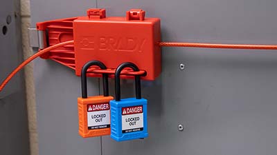 Two padlocks are attached to a breaker box lockout.