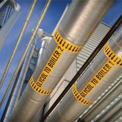 Outdoor pipes with yellow labels.
