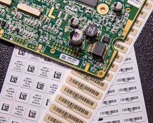 A label with text and a barcode on a circuit board.