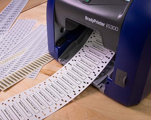 A collection of printed labels and sleeves printed on the i5300.