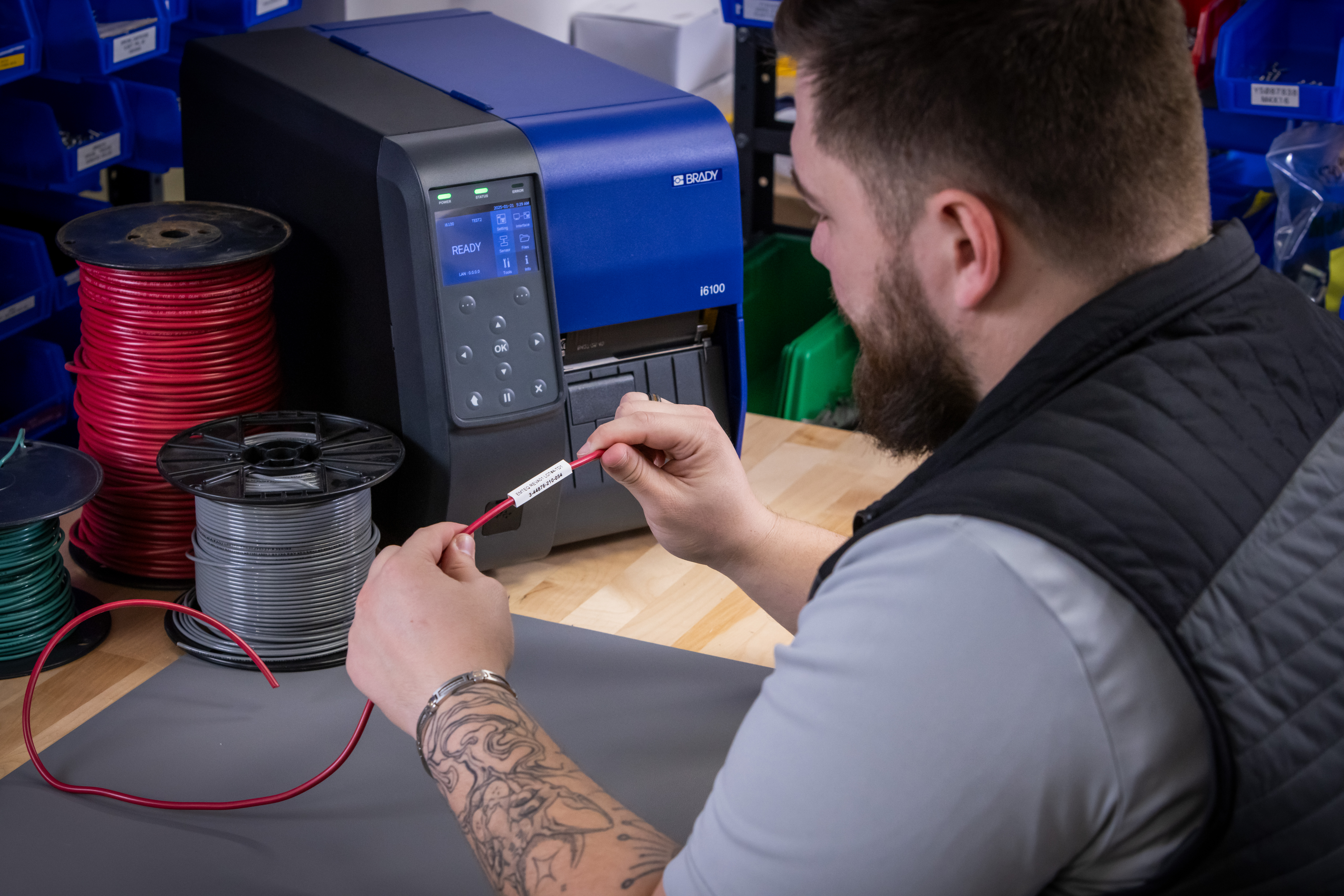 Printer on table with wire cable.