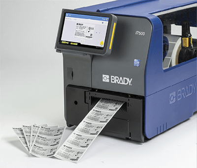 A Brady i7500 printer printing a large quantity of labels.