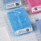 A tissue cassette identified with a white label. 