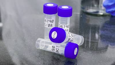 Several lab vials with Brady polyester wrap-around labels applied..