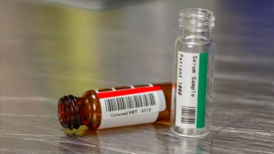 Two vials with a red and green colored labels.