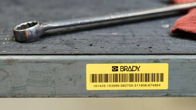 A Brady harsh environment label with a printed barcode applied to a shelf to help track its contents.