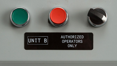A black panel identification label with white printing, reading 