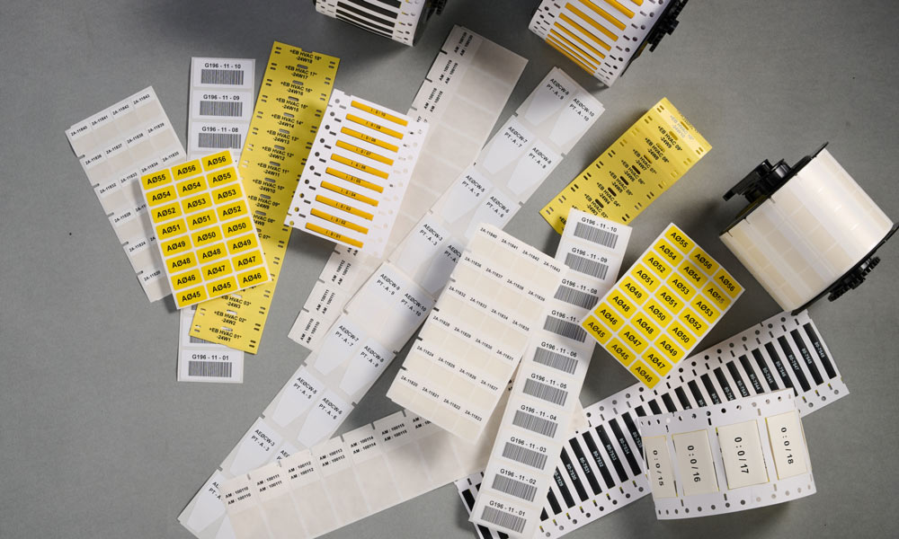 A collage of B33 series wire identification labels, covering a wide range of applications.