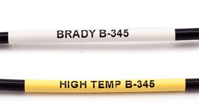 Two black cables, one labeled with a white PermaSleeve label and one with a yellow PermaSleeve label.