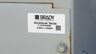 An equipment identification label with a 2D barcode on a piece of outdoor equipment.