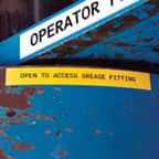 A yellow safety label applied to a piece of equipment to warn workers of a hazard.