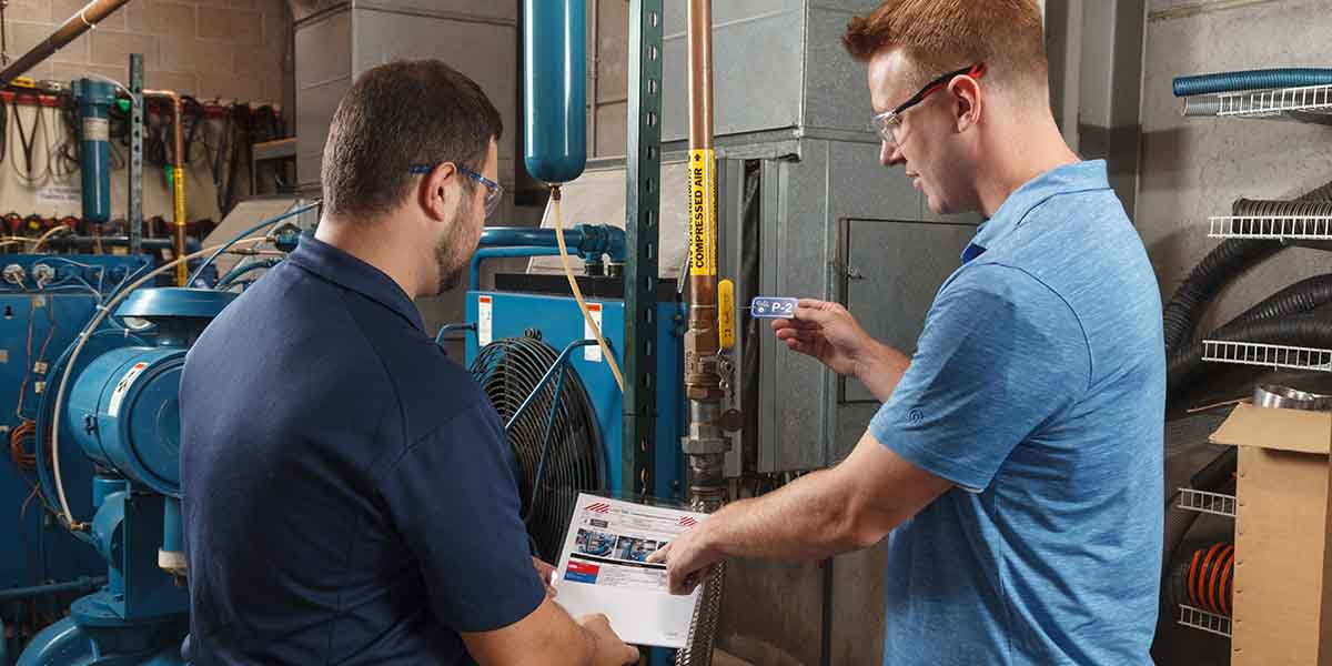 Two men looking over a lockout tagout procedure.