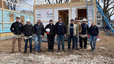 A group of employees at a Habitat for Humanity event.