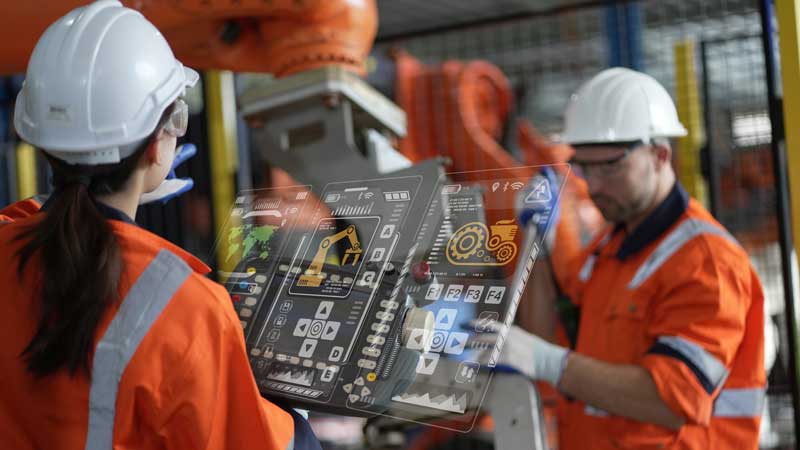 Employees harnessing the power of PLC technology to enhance manufacturing systems.